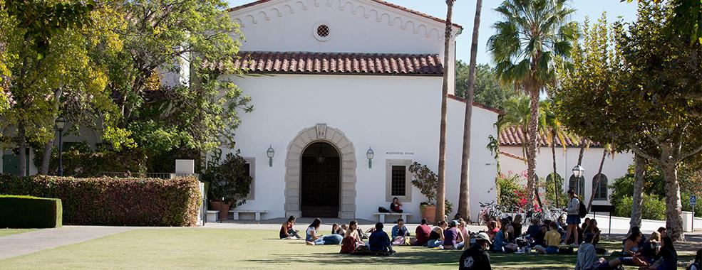 Scripps students sitting on a green lawn